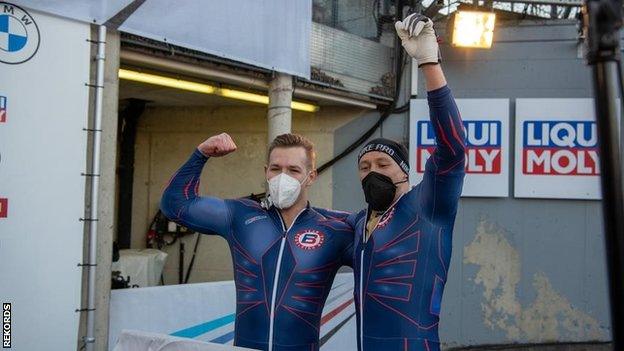 British pair Brad Hall (left) and Greg Cackett (right) celebrate winning bobsleigh World Cup bronze