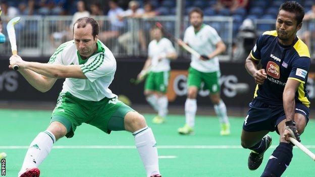 Peter Caruth prepares to score Ireland's second goal against Malaysia in the first quarter