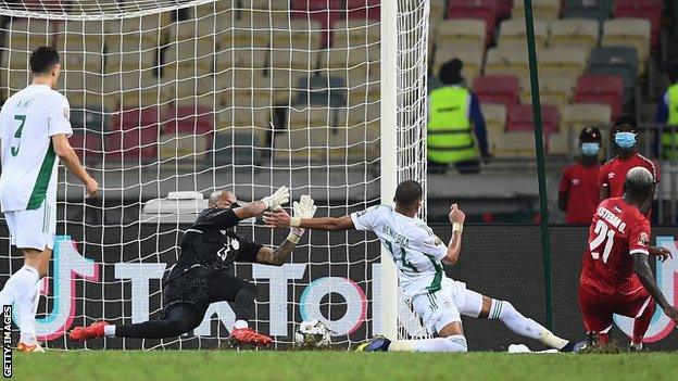 Esteban Obiang (right) slides in to score for Equatorial Guinea against Algeria