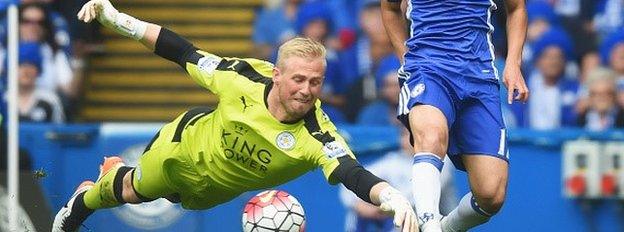 Kasper Schmeichel of Leicester City dives for the ball with Pedro Rodriguez of Chelsea