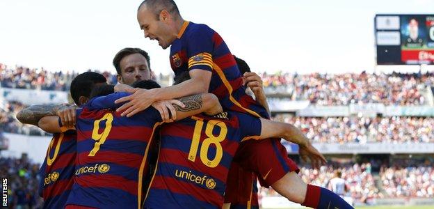 Barcelona players celebrate their third goal