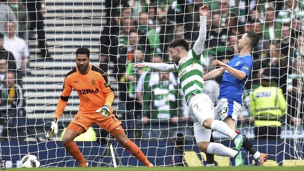 Rangers midfielder Jason Holt brings down Celtic attacker Patrick Roberts