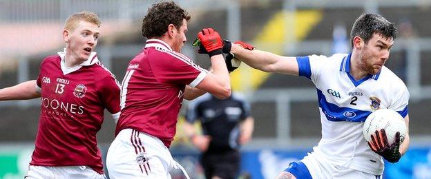 St. Vincent's Michael Concarr attempts to fend off Christopher Bradley and Paul Bradley of Slaughtneil