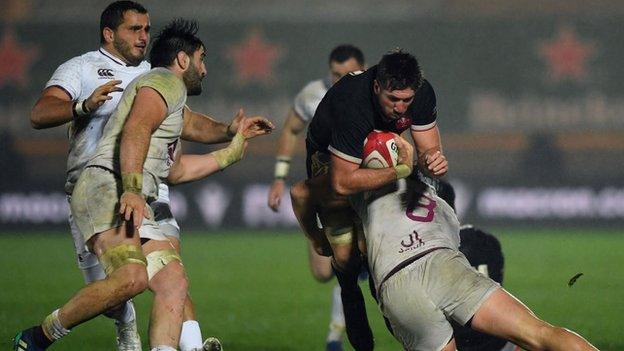 Justin Tipuric tackled as Beka Saghinadze (left) comes in with right arm