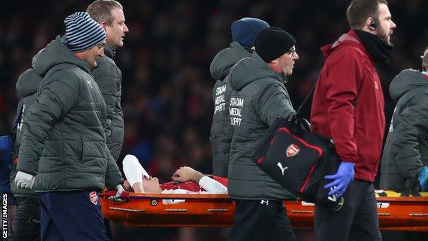 Hector Bellerin is carried off on a stretcher