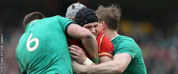 Wales' Tom James is tackled by CJ Stander and Andrew Trimble