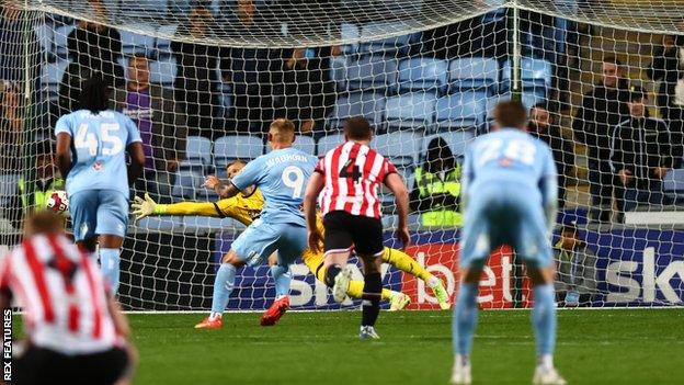 Coventry forward Martyn Waghorn (9) slots a penalty past Sheffield United goalkeeper Adam Davies