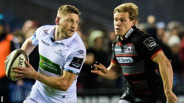 Glasgow's Finn Russell runs with the ball past Edinburgh's Nathan Fowles