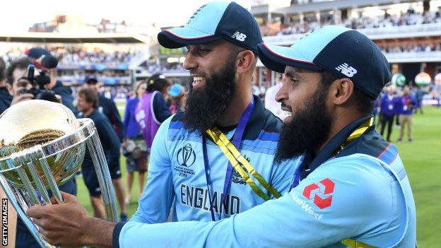 Adil Rashid (right) and Moeen Ali celebrate winning the World Cup