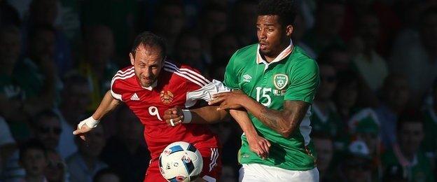 Cyrus Christie challenges Ihar Stasevich during the match at Turner's Cross