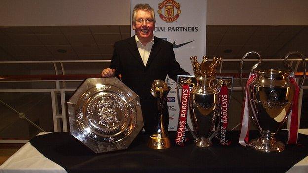 Pete Molyneux pictured with the European Cup, Premier League trophy and Community Shield