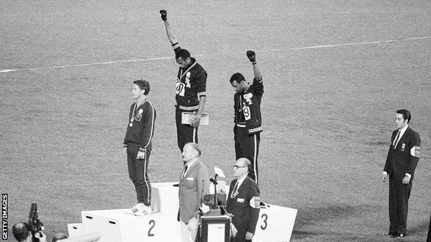 The raising of a gloved hand in protest by American athletes Tommie Smith and John Carlos at the 1968 Olympic Games