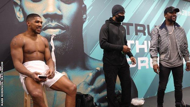 Floyd Mayweather (right) joined Anthony Joshua in his changing room after the fight