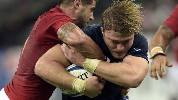 Scotland's David Denton is blocked by France's Sebastien Tillous-Borde