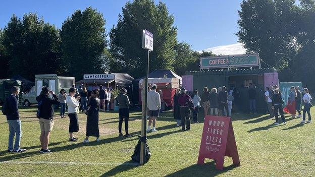 Members of the Wimbledon queue take time to grab food and drinks