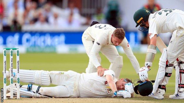 Steve Smith lies on the floor of the Lord's pitch after being hit in the head by a Jofra Archer bouncer