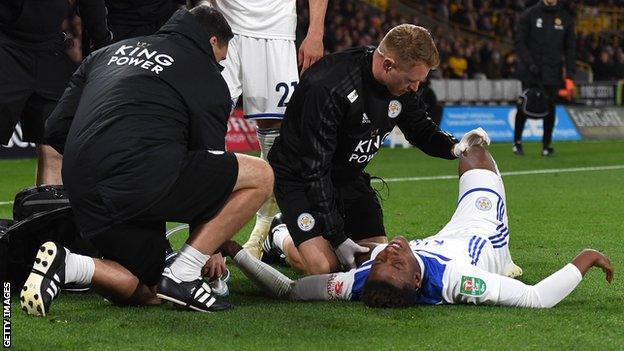 Leicester's Demarai Gray receives treatment after a heavy fall against Wolves