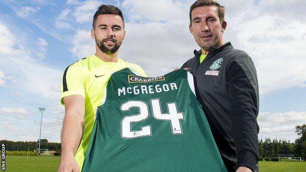 Darren McGregor shows off his new jersey with Hibs boss Alan Stubbs (right)