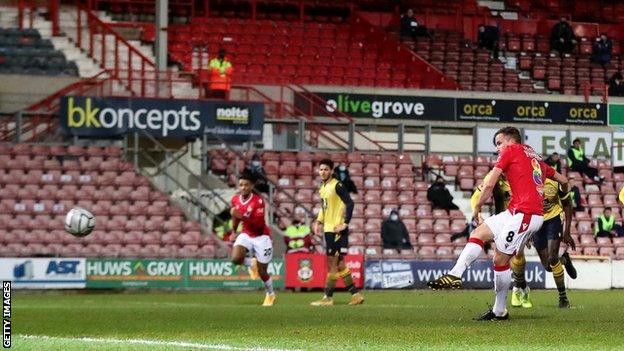 Luke Young scores from the penalty spot