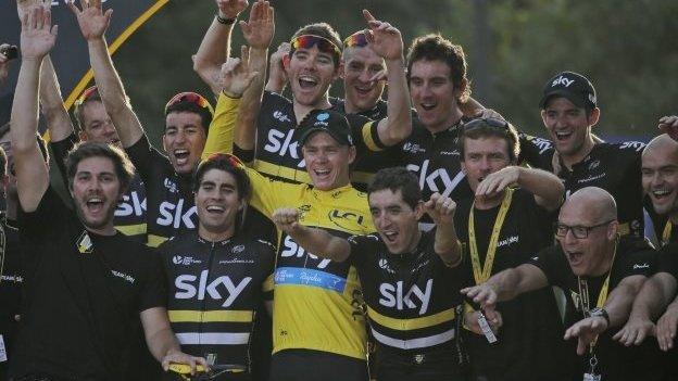 Chris Froome (in yellow) celebrates victory with Team Sky