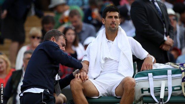 Novak Djokovic gets treatment during Wimbledon