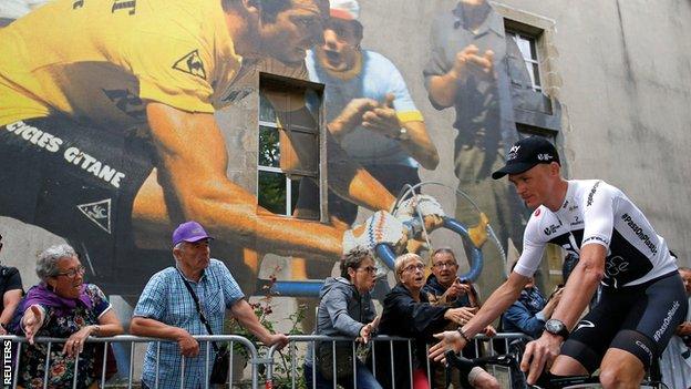 Chris Froome rides past spectators at the presentation event in La Roche-sur-Yon