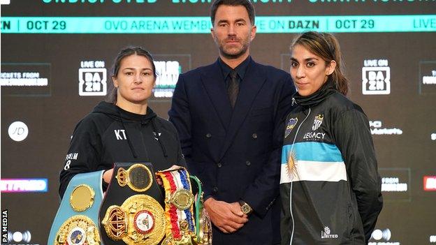 Eddie Hearn stands in between Katie Taylor and Karen Elizabeth Carbajal