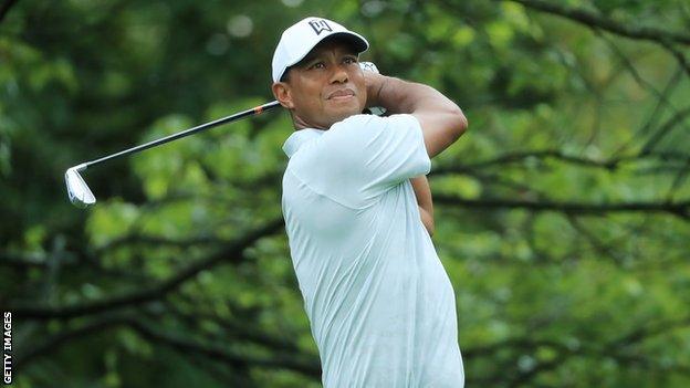 Tiger Woods holds his backswing after playing a shot