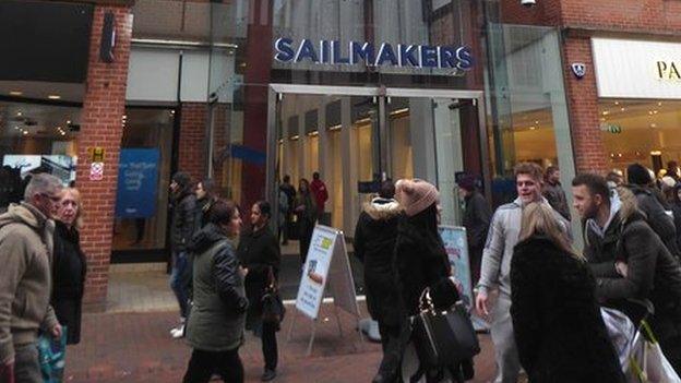 Entrance to Sailmakers shopping centre, Ipswich, with people walking past