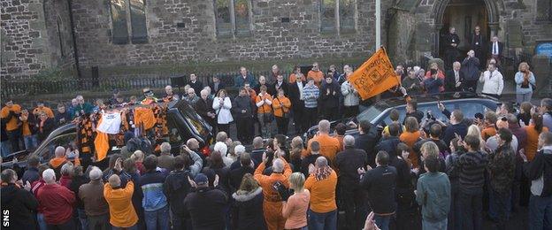 Supporters gather at the funeral of Eddie Thompson