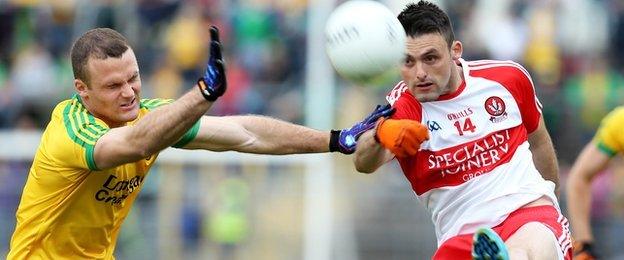 Neil McGee puts the block in on forward Eoin Bradley in the Clones semi-final