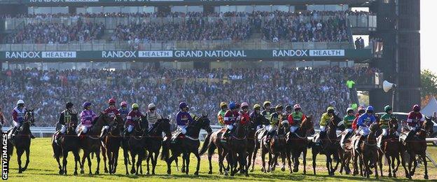 The riders and horses at the start of the Grand National