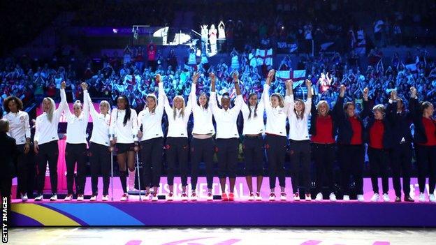 England players step on to the podium to collect their bronze medals at the World Cup