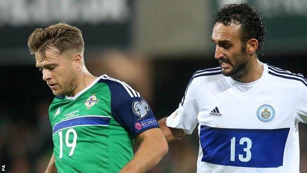 Jamie Ward of Northern Ireland and San Marino's Alessandro Della Valle battle for the ball at Windsor Park