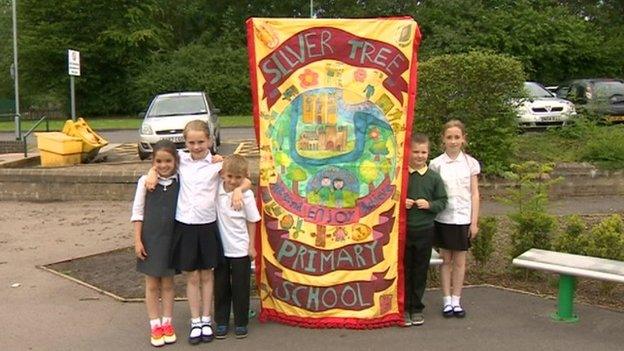 Silver Tree Primary School children with their banner