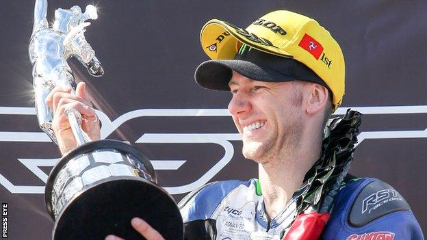 Ian Hutchinson celebrates his Superbike TT success on Saturday