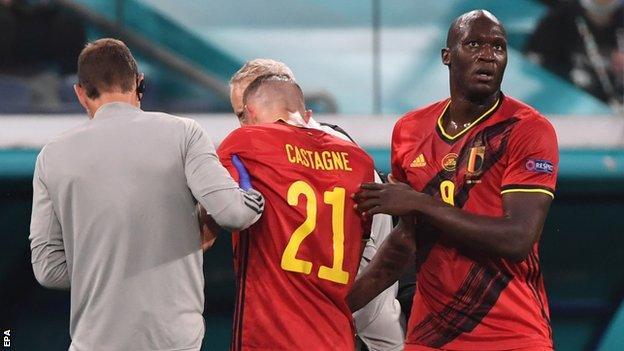 Romelu Lukaku helps Timothy Castagne off the pitck