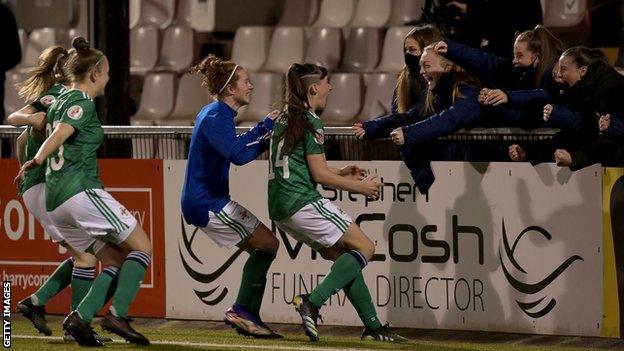 Megan Bell (second from right) celebrates Northern Ireland's historic Euro 2022 success