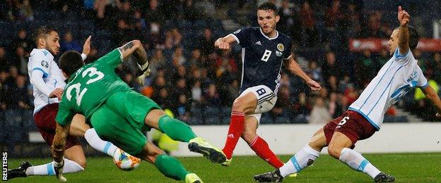 John McGinn seizes upon a loose ball to force in his second goal