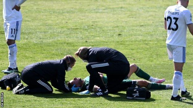 George Baldock being treated by medical staff against Leeds