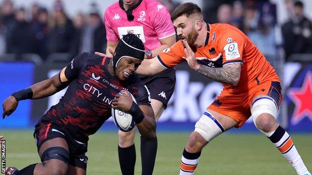 Saracens' Maro Itoje is tackled by Edinburgh's Luke Crosbie