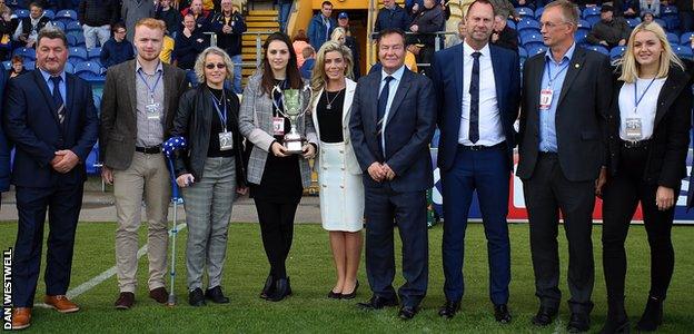 Friends and family of Matt Salmon parade the trophy named in his honour