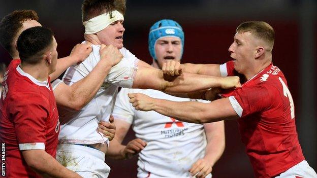 Rob Farrar of England and Frankie Jones of Wales clash during the U20s Six Nations match between England and Wales at Kingsholm Stadium