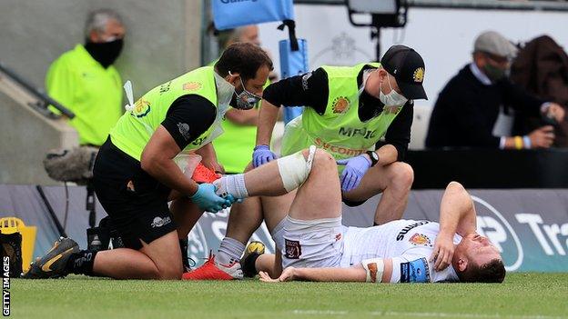 Sam Simmonds is treated for an ankle injury