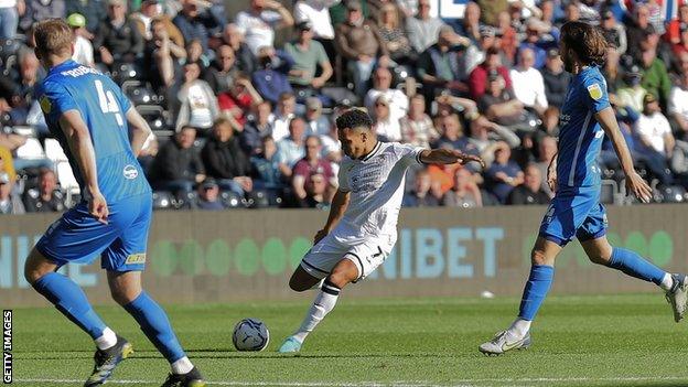 Korey Smith of Swansea City (C) takes a cross during the Sky Bet Championship match between Swansea City and Birmingham City