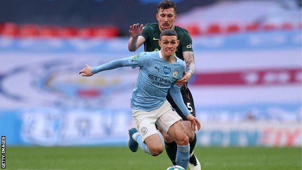 Phil Foden runs away from Pierre-Emile Hojbjerg