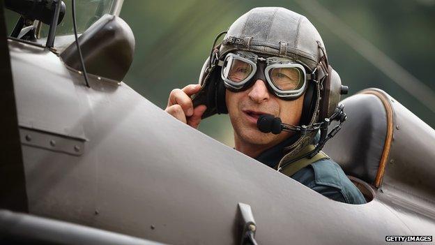 A pilot prepares for a demonstration flight in a SE5a WW1 biplane at The Shuttleworth Collection, Bedfordshire