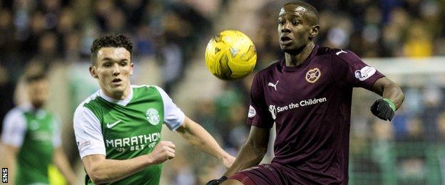 Hibs midfielder John McGinn moves in to tackle Arnaud Djoum