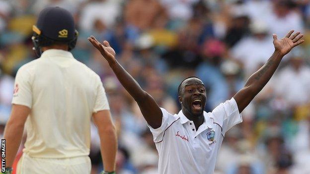 Kemar Roach celebrates a wicket