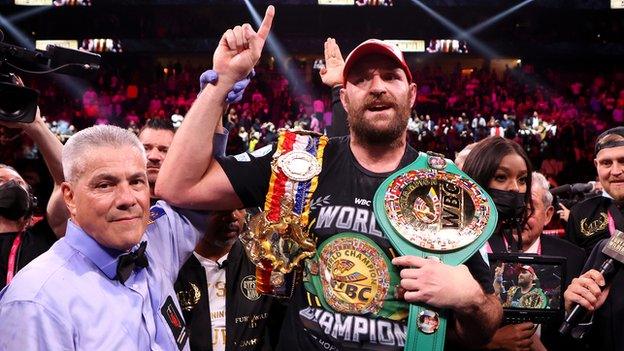 Tyson Fury has his hand raised by referee Russell Mora after defeating Deontay Wilder in their third meeting